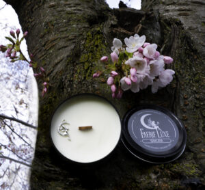 Sakura 6oz Candle next to blossoms